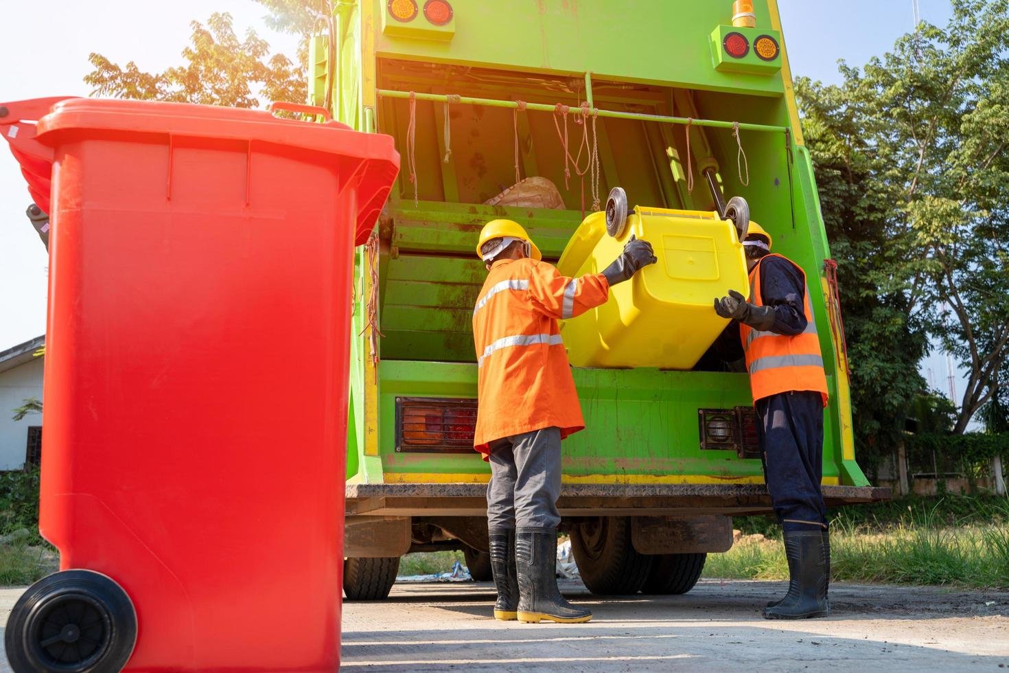 two garbage men working together free photo